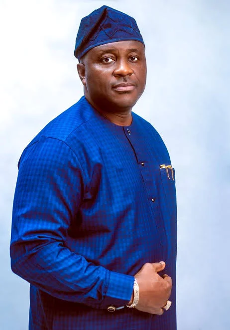 Senator Bassey Albert Akpan wearing blue traditional attire